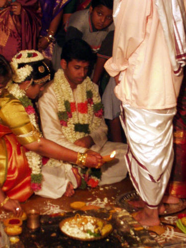 Bride and groom wash his parents feet 